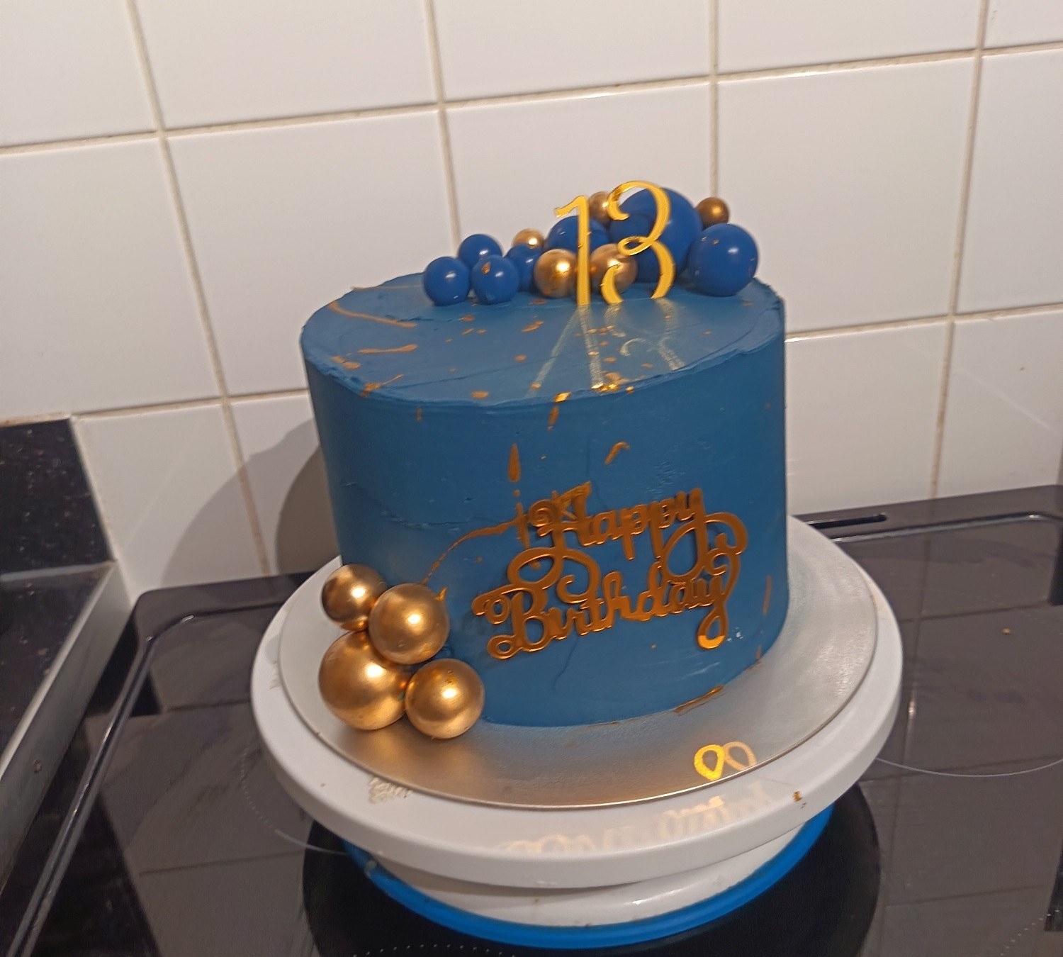 A blue 30th birthday cake with gold details
